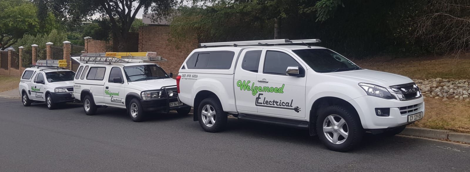 Three white Welgemoed Electrical bakkies parked in a row