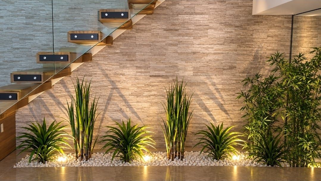 Uplights in a planter beneath a floating staircase